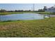 Picturesque view of a serene pond with grasses and native trees against an open sky at 3055 Leflore Ln, Orlando, FL 32833