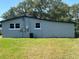 Back of home with windows and green lawn at 306 W Palm St, Davenport, FL 33837