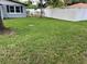 Lush backyard with manicured lawn and privacy fence offers a peaceful and private outdoor space at 306 W Palm St, Davenport, FL 33837