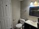 Bathroom features a modern vanity, updated fixtures, and a toilet at 306 W Palm St, Davenport, FL 33837