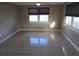Bright bedroom features tiled floors, a ceiling fan and two windows for natural light at 306 W Palm St, Davenport, FL 33837