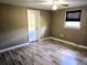 Cozy bedroom with wood-look flooring, one window, and a ceiling fan at 306 W Palm St, Davenport, FL 33837