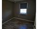 Simple bedroom with dark walls, wood-look flooring, and one window at 306 W Palm St, Davenport, FL 33837