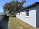 A side shot of the home's exterior, including the lawn and windows at 306 W Palm St, Davenport, FL 33837
