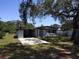 Charming single-story home with a well-manicured lawn and mature trees at 306 W Palm St, Davenport, FL 33837