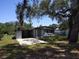 Charming single-story home with a well-manicured lawn and mature trees at 306 W Palm St, Davenport, FL 33837