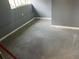 An empty garage with gray walls and epoxy floors offers potential for storage or customization at 306 W Palm St, Davenport, FL 33837