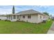 Exterior view of a single story house with a screened in porch and a green backyard at 3162 Little Sound Dr, Orlando, FL 32827