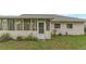 Close exterior view of the house featuring the screened-in porch with plants at 3162 Little Sound Dr, Orlando, FL 32827