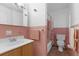 Retro pink bathroom featuring a vanity, toilet and shower tub combo with shower curtain at 3162 Little Sound Dr, Orlando, FL 32827
