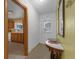 Inviting entryway showcasing a half-round table, decorative mirror, and seamless transition to the kitchen at 3162 Little Sound Dr, Orlando, FL 32827