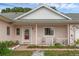 Inviting front porch with chairs, plants, and a pathway leading to the home's entrance at 3162 Little Sound Dr, Orlando, FL 32827