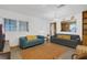 Cozy living room features bright natural light, polished terrazzo floors and comfortable seating at 3162 Little Sound Dr, Orlando, FL 32827