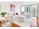 Bright condo living room features white furniture, hardwood floors, and city views at 322 E Central Blvd # 1612, Orlando, FL 32801