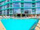 Inviting pool surrounded by lounge chairs, lush greenery, and a stylish pergola area at 322 E Central Blvd # 1612, Orlando, FL 32801