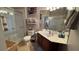 A well lit bathroom featuring a glass door shower, tile flooring and a dark wood vanity at 3338 Robert Trent Jones Dr # 30704, Orlando, FL 32835