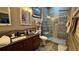 Beautiful bathroom with modern walk-in shower, vanity, and earth tone tile at 3338 Robert Trent Jones Dr # 30704, Orlando, FL 32835
