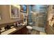 Beautiful bathroom with modern walk-in shower, vanity, and earth tone tile at 3338 Robert Trent Jones Dr # 30704, Orlando, FL 32835