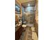 A well lit bathroom featuring a glass door shower, mosaic tile flooring and a dark wood vanity at 3338 Robert Trent Jones Dr # 30704, Orlando, FL 32835