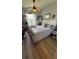 An inviting bedroom with a fluffy, soft bed, wood ceiling fan and wood-look flooring at 3338 Robert Trent Jones Dr # 30704, Orlando, FL 32835