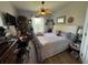 A comfortable bedroom with a spacious bed, ceiling fan and light-colored flooring at 3338 Robert Trent Jones Dr # 30704, Orlando, FL 32835