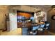 Modern kitchen featuring dark wood cabinetry, stainless steel appliances, an island with seating, and tile flooring at 3338 Robert Trent Jones Dr # 30704, Orlando, FL 32835