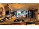 Spacious kitchen with granite countertops, dark wood cabinets, and open view into the living and dining area at 3338 Robert Trent Jones Dr # 30704, Orlando, FL 32835