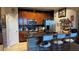 Modern kitchen featuring dark wood cabinetry, stainless steel appliances, an island with seating, and tile flooring at 3338 Robert Trent Jones Dr # 30704, Orlando, FL 32835