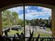Scenic view from the screened lanai shows the parking area with pond and lush landscaping beyond at 3338 Robert Trent Jones Dr # 30704, Orlando, FL 32835