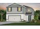 Two-story home with a two-car garage, gray siding, and tasteful landscaping at 3406 Haven Side Rd, Davenport, FL 33837
