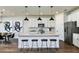 Modern kitchen featuring stainless steel appliances, a center island with bar stools, and ample cabinet space at 3406 Haven Side Rd, Davenport, FL 33837