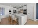 Bright kitchen with stainless steel appliances, white cabinetry, and island seating at 3406 Haven Side Rd, Davenport, FL 33837
