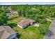 Aerial view of the home with a well manicured lawn surrounded by lush trees at 3685 Sunday Dr, Deltona, FL 32738