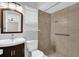 Well-lit bathroom featuring a tiled shower, modern sink and vanity at 3685 Sunday Dr, Deltona, FL 32738
