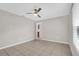 Comfortable bedroom with tiled floor, ceiling fan, and neutral walls for easy customization at 3685 Sunday Dr, Deltona, FL 32738