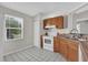 Functional kitchen with white appliances, classic wood cabinets, and a bright window at 3685 Sunday Dr, Deltona, FL 32738