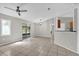 Open-concept living room showcasing tile flooring, neutral colors, and sliding glass doors at 3685 Sunday Dr, Deltona, FL 32738