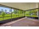 Relax on this screened porch with views of the large green backyard at 3685 Sunday Dr, Deltona, FL 32738