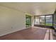 View of the screened porch that faces part of the yard with lush grass at 3685 Sunday Dr, Deltona, FL 32738