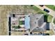 A bird's-eye view highlights the private, fenced backyard with mature landscaping and a covered patio at 372 Willet St, Haines City, FL 33844