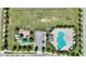 An aerial view shows the community park with a playground, sports field, and swimming pool with ample parking and landscaping at 372 Willet St, Haines City, FL 33844