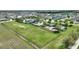 An aerial view showcasing a fenced sports field, playground, and pool in a well-planned community with Gathering-friendly amenities at 372 Willet St, Haines City, FL 33844