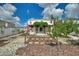 Beautifully landscaped backyard with stone pathways and a pergola-covered patio is perfect for outdoor enjoyment at 372 Willet St, Haines City, FL 33844