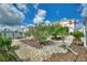 Landscaped backyard featuring stone pavers, garden beds, and a convenient storage shed is a delight at 372 Willet St, Haines City, FL 33844