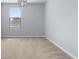 Bedroom featuring neutral carpet, a modern light fixture, and a window providing natural light at 372 Willet St, Haines City, FL 33844