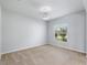 Bright bedroom with neutral carpet, a window, and a modern light fixture at 372 Willet St, Haines City, FL 33844