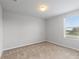 A bedroom features carpet, neutral walls and a window offering natural light and serene atmosphere at 372 Willet St, Haines City, FL 33844