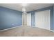 Bedroom featuring blue walls, neutral carpet, a modern light fixture, and a closet at 372 Willet St, Haines City, FL 33844