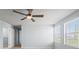 A bedroom featuring neutral carpet, a ceiling fan, and a pair of windows providing natural light at 372 Willet St, Haines City, FL 33844