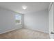 A light-filled bedroom with neutral carpet, walls and a window offering natural light at 372 Willet St, Haines City, FL 33844